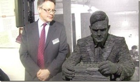 Alan Turing's nephew Sir John Dermot Turing looks at Stephen Kettle's sculpture of his uncle at the exhibition