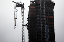 NEW YORK, NY - OCTOBER 29: Part of a crane boom is seen hanging off a building under construction on West 57th Street
on October 29, 2012 in Manhattan, New York City. The storm, which threatens 50 million people in the eastern third of the U.S., is expected to bring days of rain, high winds and possibly heavy snow. New York Governor Andrew Cuomo announced the closure of all New York City will bus, subway and commuter rail service as of Sunday evening. (Photo by Allison Joyce/Getty Images)