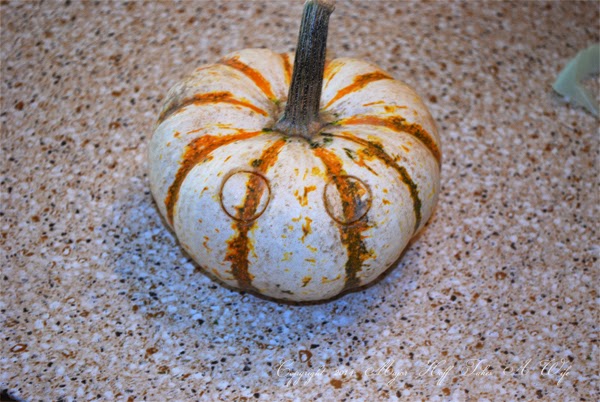 Making eye holes in pumpkins.jpg Making eye holes in pumpkins