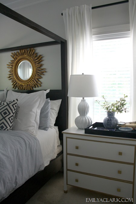 master bedroom with white and gold chest
