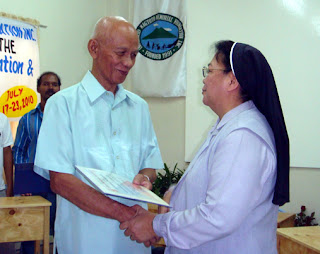 MCCID College President Remberto C. Esposa receives certificate of membership from CTED Project Head Sis Agnetia Naval.