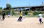 Boys and futball with border patrol in the background.