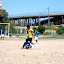 Boys and futball with border patrol in the background.