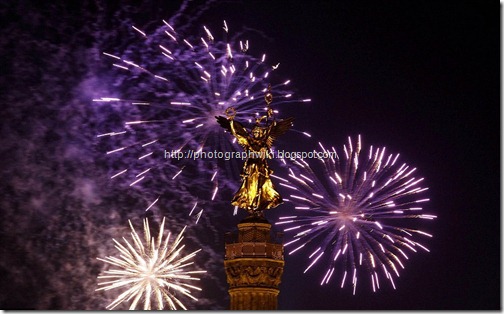 Fireworks explode before New Year celebrations over the 'Golden Victoria' on top of Berlin's landmark victory column
