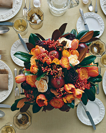 Pomegranates, red viburnum berries, tulips, roses, ranunculus, and a bronzy-green magnolia-leaf wreath are all used to create the perfect Thanksgiving centerpiece. Pomegranates, red viburnum berries, tulips, roses, ranunculus, and a bronzy-green magnolia-leaf wreath are all used to create the perfect Thanksgiving centerpiece.