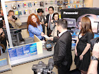 Brad and Ashley are handed the receipt from their purchase of Panasonic's first Full HD 3D Home Theater System.