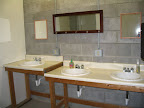 each restroom has 3 showers, stools, and sinks
