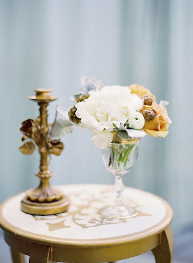 Gold-rimmed crystal goblets adorned accent tables.