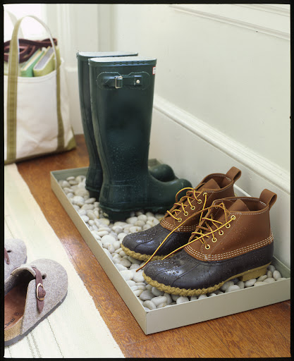 A tray in an entryway keeps boots and shoes neat and contained. In the spring, add some river rocks to help the water drain off and evaporate. A tray in an entryway keeps boots and shoes neat and contained. In the spring, add some river rocks to help the water drain off and evaporate.