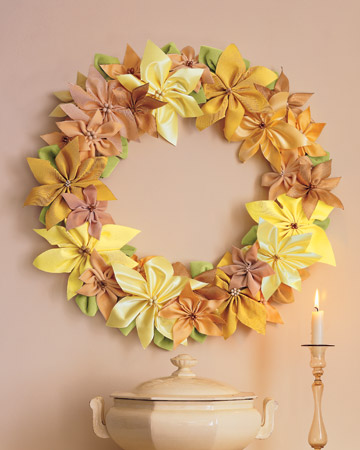 Brighten your walls with a wreath made of golden-hued ribbons fashioned into poinsettias. Brighten your walls with a wreath made of golden-hued ribbons fashioned into poinsettias.