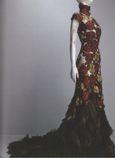 McQueen pairs the daisy print with a feathered train, lending the gown a more serious and elegant style. McQueen pairs the daisy print with a feathered train, lending the gown a more serious and elegant style.