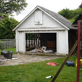 With the siding removed on both sides, the garage is ready to be pulled down