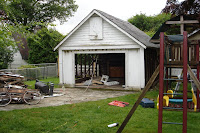 With the siding removed on both sides, the garage is ready to be pulled down