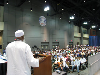 A stage shot behind Imam Siraj