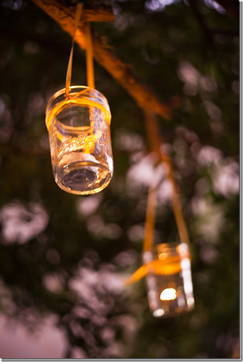 Along with the string lights votives were placed in hanging jam jars