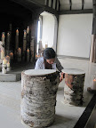 Katie adjusts the felt on top of the log stools.