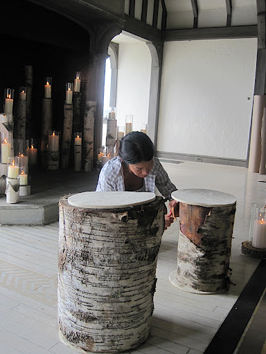 Katie adjusts the felt on top of the log stools.