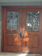 Custom entry door with clear GNA bevels and fused and beveled leaves and branch in brushed lead came.