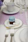 Each place setting includes a small plate with sugar cubes and a tiny jar of honey for flavoring the tea. Each place setting includes a small plate with sugar cubes and a tiny jar of honey for flavoring the tea.
