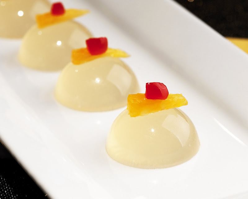 Tom Collins shot garnished with orange and maraschino cherry