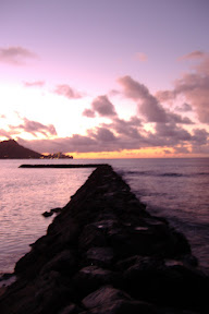 There was a rock barrier going out into the water.  I walked down to the end of it for some shots, and took a video.  The rocks were black, volcanic stuff.
