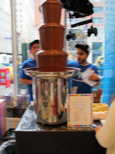 These gentlemen dipped marshmallow and rice squares into a chocolate fountain. Talk about chocolate on the go! These gentlemen dipped marshmallow and rice squares into a chocolate fountain. Talk about chocolate on the go!