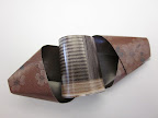 For the final center twist, use a very short strip to make a little cylinder and tape it into the middle.