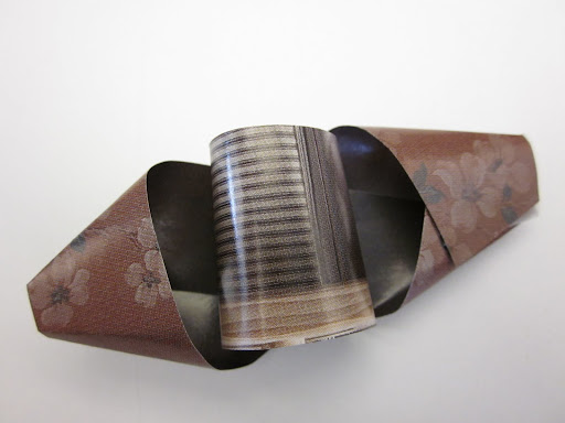 For the final center twist, use a very short strip to make a little cylinder and tape it into the middle. For the final center twist, use a very short strip to make a little cylinder and tape it into the middle.