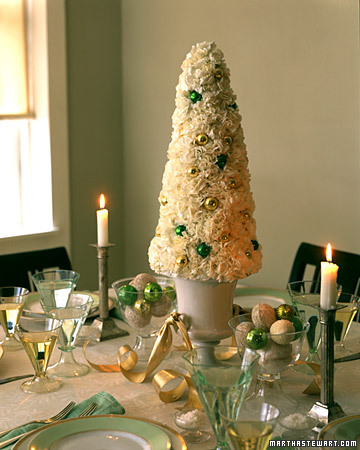 The green and white combo of this tablescape is subtle, yet festive. Carnations were used to evoke a snow-covered tree and green and white ornaments were placed in compotes to complete the centerpiece. The green and white combo of this tablescape is subtle, yet festive. Carnations were used to evoke a snow-covered tree and green and white ornaments were placed in compotes to complete the centerpiece.