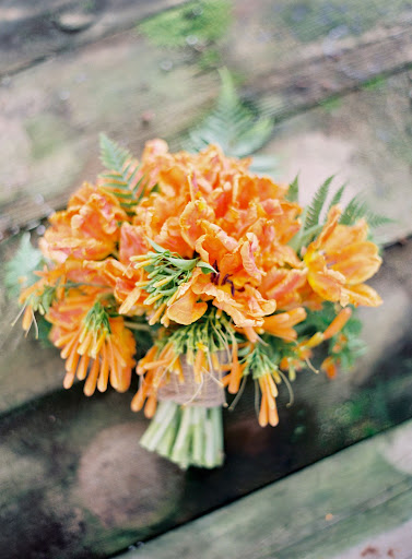 The bouquet features orange 'Monarch Parrot' tulips and foraged trumpet vine -- it grows rampant during California's winters. The bouquet features orange 'Monarch Parrot' tulips and foraged trumpet vine -- it grows rampant during California's winters.