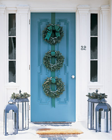 Instead of just one wreath adorning your door, tie three wreaths together with thick ribbon.