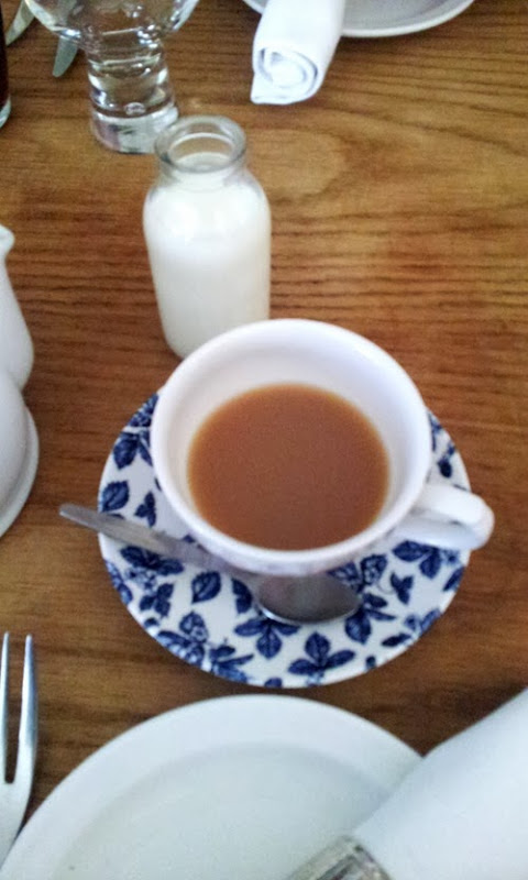 Tea with tiny milk bottle Tea with tiny milk bottle