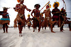 Indigenous marchers on Rio’s Flamengo Beach on June 19, 2012. Their bodies formed the lines of an enormous image promoting the importance of free-running rivers, truly clean energy sources like solar power and including indigenous knowledge as part of the solution to climate issues. The activity was led by Brazil’s many indigenous peoples organized under the umbrella of the Articulation of Brazilian Indigenous Peoples. ©Caroline Bennett