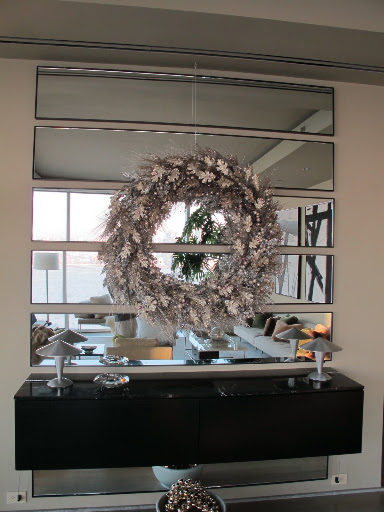 I suspended a gilded wreath from the ceiling in my entryway to welcome guests as they arrive.