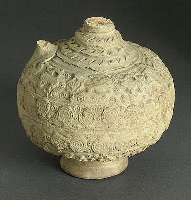 Bottle | Origin: Syria | Period: Early Medieval or Late Medieval | Collection: The Madina Collection of Islamic Art, gift of Camilla Chandler Frost (M.2002.1.90) | Type: Ceramic; Vessel, Earthenware, molded and incised with applied neck, foot, and handle, Height: 9 1/2 in. (24.13 cm)
