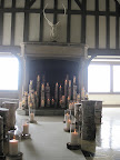 Pillar candles in hurricane glasses sat atop log slices.