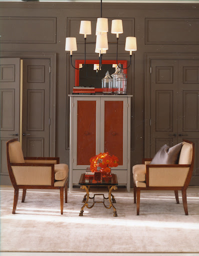 This simple furniture arrangement is completely symmetrical–built around a traditional chandelier. This simple furniture arrangement is completely symmetrical–built around a traditional chandelier.
