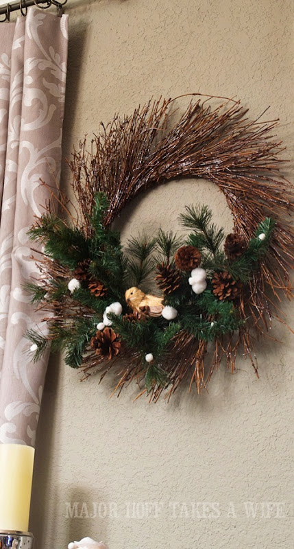 World Market winter wreath knock off. World Market inspired wreath. A fun twist on a Christmas wreath. Make a winter wreath that will last all season long and well past. This cute grapevine wreath is adorned with a tiny bird, pinecones, greenery and pom poms. You won't believe how cheap and easy this was to make! And so simple! #Christmas #winter #holiday #wreath #nature #knockoff World Market winter wreath knock off. World Market inspired wreath. A fun twist on a Christmas wreath. Make a winter wreath that will last all season long and well past. This cute grapevine wreath is adorned with a tiny bird, pinecones, greenery and pom poms. You won't believe how cheap and easy this was to make! And so simple! #Christmas #winter #holiday #wreath #nature #knockoff