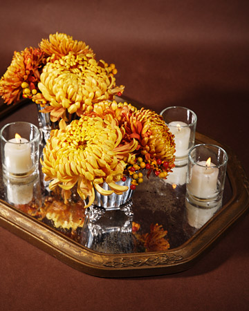 You can enhance a flower arrangement by placing a framed mirror underneath.