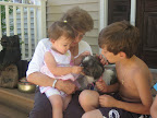 Julie shows grandchildren Theresa and John how to gently pet Rosie Julie shows grandchildren Theresa and John how to gently pet Rosie