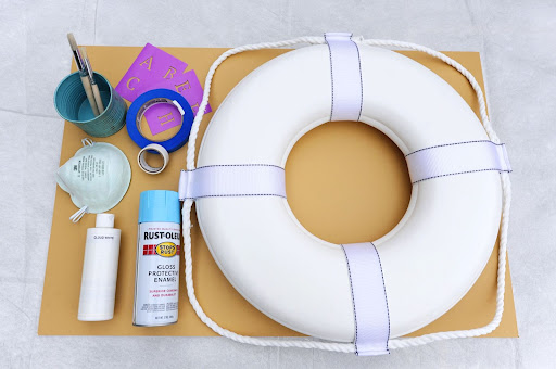 The next project -- a stenciled welcome sign for your seaside celebration -- requires a small life preserver (available at any marine or boat shop), painter’s tape, spray paint, letter stencils, a stencil brush, white paint, and a safety mask. The next project -- a stenciled welcome sign for your seaside celebration -- requires a small life preserver (available at any marine or boat shop), painter’s tape, spray paint, letter stencils, a stencil brush, white paint, and a safety mask.