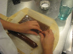 After the caramel cools, she rolls it into logs.