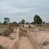 Canal is hand-dug across the rice fields.