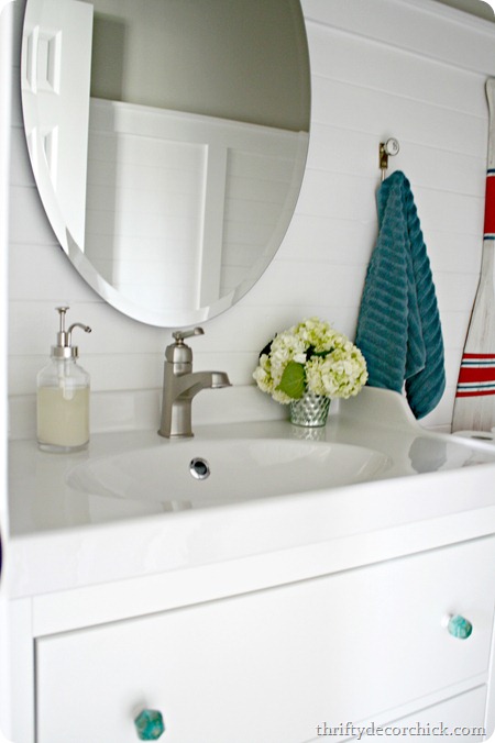 oval mirror over bathroom sink