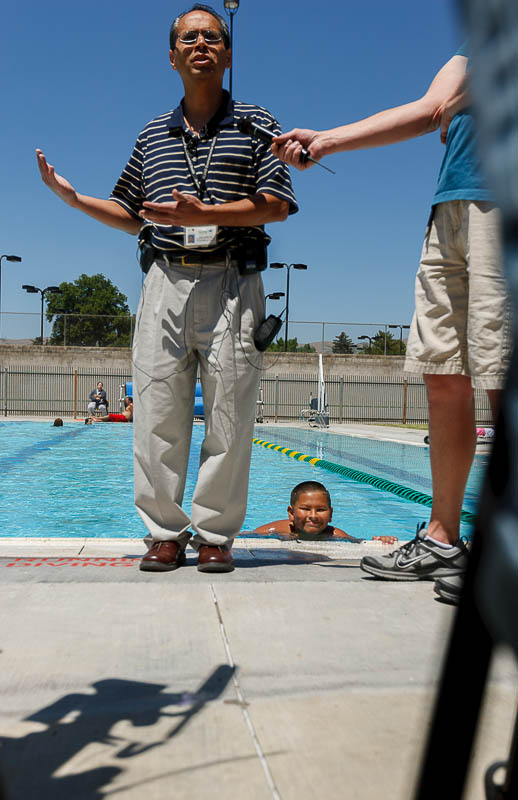Rick Ledbetter, Environmental Health Supervisor for the Salt Lake Valley Health Department, urged residents to defend themselves against waterborne illnesses at a press conference at the Liberty Park pool. In the pool behind Ledbetter is Ruben Saldivar.