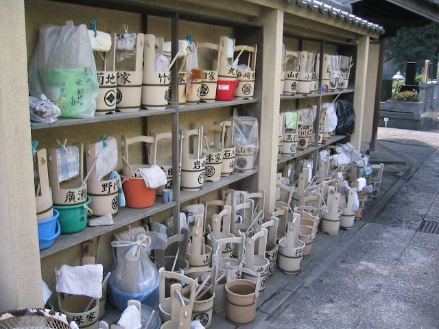 Water buckets for cleaning families' haka (family graves)