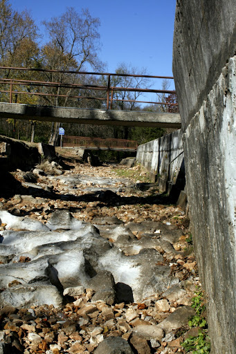 Structures such as this high channel wall will be removed completely in exchange for a stepped terrace design making the parks waterway safer, and more accessible. (Photo By: Kenrick Nobles)