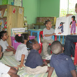 Aldiani is excited to help read. Wilton, Emely, Elianny, Lucia and Erickson are enthralled.