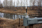 Northwest side of middle channel near Victor Bridge - this sign is trying to hang on. Need to be restapled to the plywood.