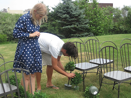 Anthony helps with the smaller topiaries that perched next to the iron chairs.